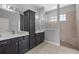 Bathroom featuring double vanity, glass block window, and tiled walk-in shower at 10138 Lake Miona Way, Oxford, FL 34484