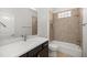 Bathroom vanity and shower with tile surround and glass block window at 10138 Lake Miona Way, Oxford, FL 34484