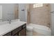 Well-lit bathroom featuring a tiled shower-bathtub combination and modern fixtures at 10138 Lake Miona Way, Oxford, FL 34484