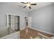 Bedroom featuring hardwood floors, a ceiling fan, and a closet at 10138 Lake Miona Way, Oxford, FL 34484