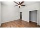 Bright bedroom features hardwood flooring, a ceiling fan, and closet space at 10138 Lake Miona Way, Oxford, FL 34484