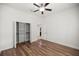 Bedroom with hardwood floors, ceiling fan and walk-in closet at 10138 Lake Miona Way, Oxford, FL 34484