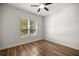 Cozy bedroom with natural light, ceiling fan, and hardwood flooring at 10138 Lake Miona Way, Oxford, FL 34484