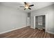 Bright bedroom with wood floors, ceiling fan, and closet storage at 10138 Lake Miona Way, Oxford, FL 34484