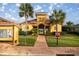 Charming community building with lush landscaping and welcoming entrance at 10138 Lake Miona Way, Oxford, FL 34484
