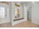 Bright foyer featuring tile floors, a bench seat with storage, and a decorative glass front door at 10138 Lake Miona Way, Oxford, FL 34484