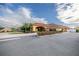 Exterior shot of a clubhouse featuring beautiful landscaping, an inviting circular driveway, and an elegant facade at 10138 Lake Miona Way, Oxford, FL 34484