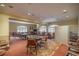 Spacious game room featuring multiple tables and comfortable seating, perfect for entertaining guests at 10138 Lake Miona Way, Oxford, FL 34484