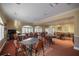 Bright and airy game room, offering a variety of tables and seating for friendly competition and entertainment at 10138 Lake Miona Way, Oxford, FL 34484