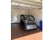 A golf cart parked inside the two-car garage with overhead storage, providing secure parking at 10138 Lake Miona Way, Oxford, FL 34484