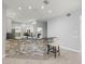 Open kitchen layout with stone accent bar, pendant lighting, and neutral color palette at 10138 Lake Miona Way, Oxford, FL 34484