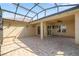 Spacious covered lanai with tile flooring, ceiling fan, and ample room for outdoor seating at 10138 Lake Miona Way, Oxford, FL 34484