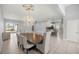 Open concept living room and dining area features a large chandelier and seamless flow at 10138 Lake Miona Way, Oxford, FL 34484