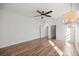 Bright living room boasts hardwood floors, ceiling fan, and contemporary chandelier at 10138 Lake Miona Way, Oxford, FL 34484