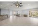 Open-concept living room featuring tile flooring, ample space, and sliding glass doors to the outdoor area at 10138 Lake Miona Way, Oxford, FL 34484