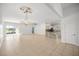 Spacious living area with tiled floors, stone-accented bar, chandelier, sliding glass doors with views of the backyard at 10138 Lake Miona Way, Oxford, FL 34484