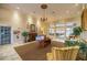 Inviting lobby with fireplace, elegant chandelier, and comfortable seating, creating a warm and welcoming atmosphere at 10138 Lake Miona Way, Oxford, FL 34484
