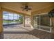 Enclosed patio overlooks a picturesque lake with a fountain feature at 10138 Lake Miona Way, Oxford, FL 34484
