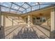 Spacious screened patio featuring a stone floor, ceiling fan, and ample space for entertaining at 10138 Lake Miona Way, Oxford, FL 34484