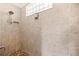 Close-up of tiled walk-in shower with niche and window at 10138 Lake Miona Way, Oxford, FL 34484