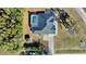 Aerial shot reveals a private backyard pool and home layout amidst verdant trees, offering a tranquil retreat at 10215 Sw 134Th Ct, Dunnellon, FL 34432