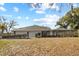 Expansive backyard featuring a screened-in pool and covered patio at 10215 Sw 134Th Ct, Dunnellon, FL 34432