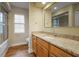 Bathroom featuring granite counters, wood cabinets, and a shower/tub combo at 10215 Sw 134Th Ct, Dunnellon, FL 34432