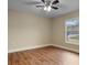 Bedroom with wood-look flooring, neutral walls, and a ceiling fan at 10215 Sw 134Th Ct, Dunnellon, FL 34432