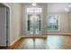 Bright foyer featuring beautiful wood floors and a grand entrance with glass doors at 10215 Sw 134Th Ct, Dunnellon, FL 34432