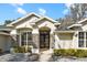 Charming home exterior showcases stone accents, arched entryway, and a well-manicured lawn, adding curb appeal at 10215 Sw 134Th Ct, Dunnellon, FL 34432