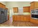 Kitchen featuring stainless steel appliances, wood cabinets, and stone backsplash at 10215 Sw 134Th Ct, Dunnellon, FL 34432