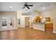 Spacious living area featuring wood floors, a ceiling fan, and an open floor plan to the kitchen at 10215 Sw 134Th Ct, Dunnellon, FL 34432