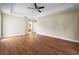 Spacious main bedroom features a tray ceiling, ceiling fan, and wood-look flooring at 10215 Sw 134Th Ct, Dunnellon, FL 34432