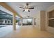 A covered patio with tiled flooring and ceiling fans extends to a screened-in pool area at 10215 Sw 134Th Ct, Dunnellon, FL 34432