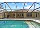 A view of the pool and screened-in area, with the backyard extending beyond the enclosure at 10215 Sw 134Th Ct, Dunnellon, FL 34432