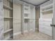 Organized walk-in closet with shelving, hanging rods, and built-in drawers for storage at 10215 Sw 134Th Ct, Dunnellon, FL 34432