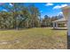 Expansive backyard perfect for outdoor activities and relaxation, surrounded by lush trees at 10657 Sw 110Th Ct, Dunnellon, FL 34432