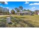 Spacious backyard featuring lush grass and an outdoor well system at 10657 Sw 110Th Ct, Dunnellon, FL 34432