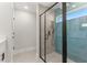 Modern bathroom featuring a glass-enclosed shower with blue tile accents, black hardware and fixtures at 10657 Sw 110Th Ct, Dunnellon, FL 34432