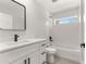 Stylish bathroom featuring modern vanity, tub, and tiled shower with window at 10657 Sw 110Th Ct, Dunnellon, FL 34432