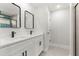 Bathroom featuring double vanity with black hardware, a glass enclosed shower with blue tile accents and modern fixtures at 10657 Sw 110Th Ct, Dunnellon, FL 34432