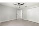 Bedroom boasts gray tile floors, a ceiling fan, and closet for ample storage at 10657 Sw 110Th Ct, Dunnellon, FL 34432