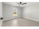 Cozy bedroom with gray tile floors, a window, and modern ceiling fan at 10657 Sw 110Th Ct, Dunnellon, FL 34432