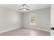 This bedroom features gray tile floors, a window, and modern ceiling fan at 10657 Sw 110Th Ct, Dunnellon, FL 34432