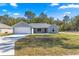 Charming single-story home featuring a two-car garage and a well-maintained lawn at 10657 Sw 110Th Ct, Dunnellon, FL 34432