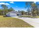 Spacious front yard with a long driveway leading to a charming single-story home at 10657 Sw 110Th Ct, Dunnellon, FL 34432