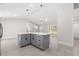 Kitchen island with gray cabinetry, white countertop, and pendant lighting at 10657 Sw 110Th Ct, Dunnellon, FL 34432