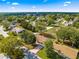 Expansive aerial view of the property nestled within a lush, green community and mature trees at 11620 Sw 84Th Avenue Rd, Ocala, FL 34481