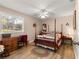 Cozy bedroom with a ceiling fan, a bright window and a wood-themed floor at 11620 Sw 84Th Avenue Rd, Ocala, FL 34481