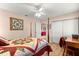 Bedroom showcasing hard wood floors, ceiling fan, and a well-lit interior at 11620 Sw 84Th Avenue Rd, Ocala, FL 34481